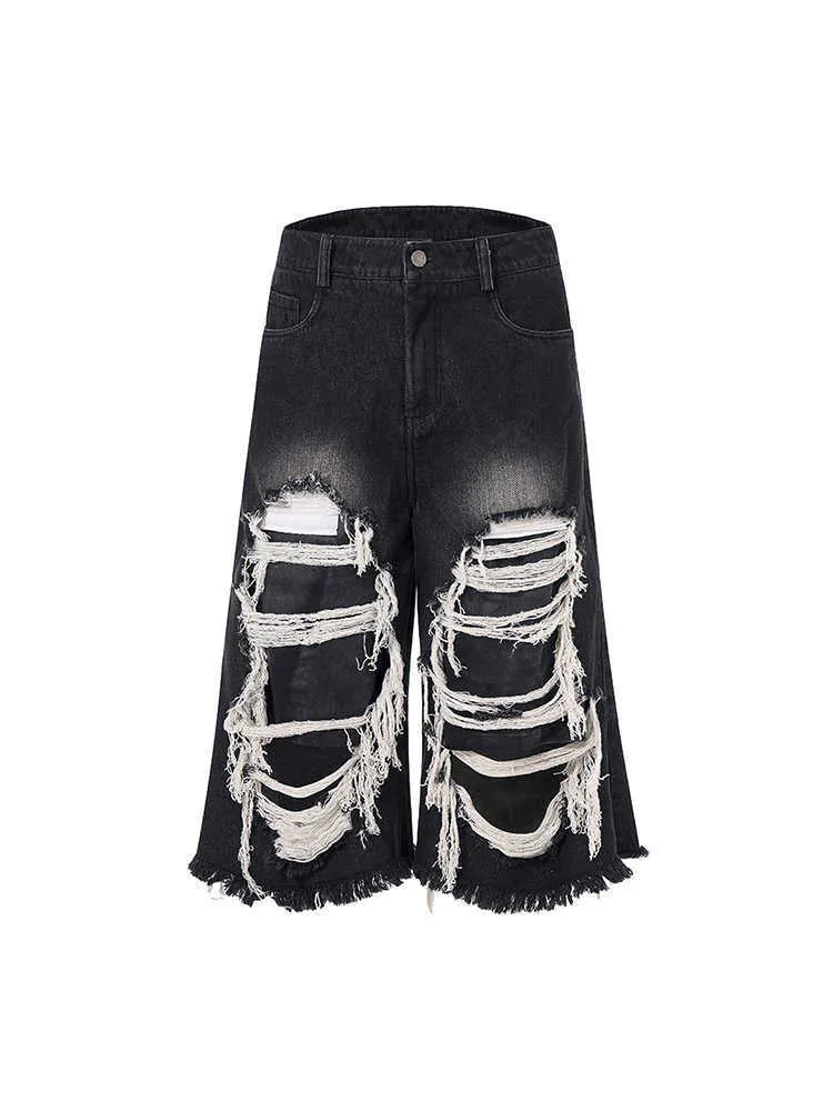 Black cropped wide-leg jeans with mid-high waist on mannequin showing loose fit and micro-elastic cotton denim