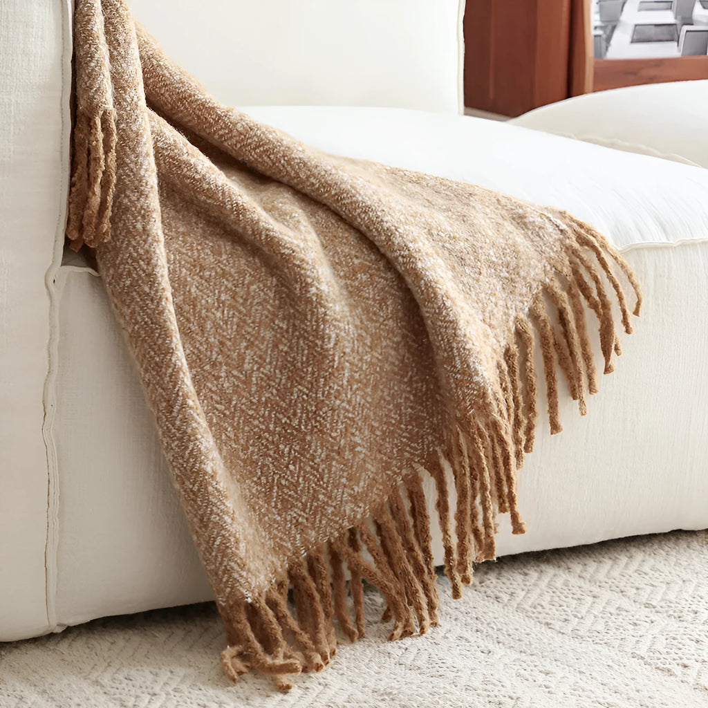 Navy blue polyester fibre leisure blanket folded on a simple sofa