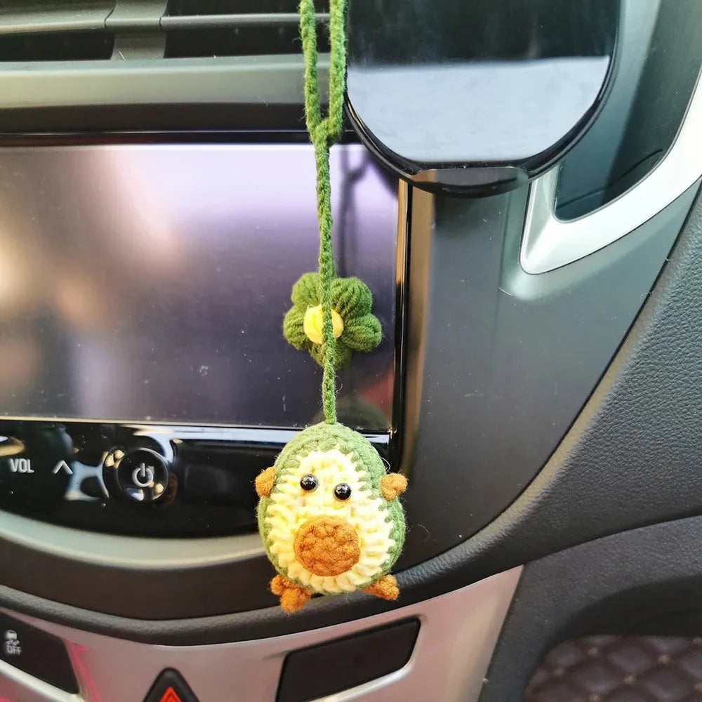 Handmade crocheted rainbow flower car pendant in wool yarn with avocado, pink, and red colour options