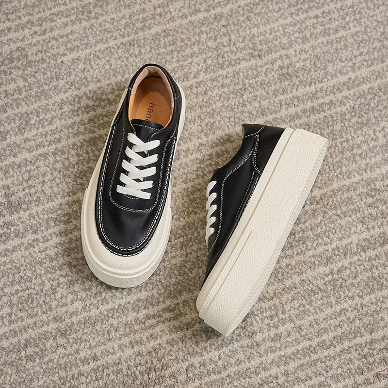 Women's black platform casual sports shoes with embossed cowhide leather upper and round toe design