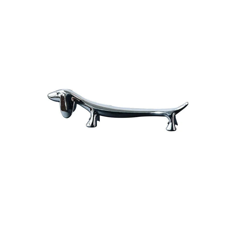 Silver zinc alloy sausage dog chopstick rest on a table