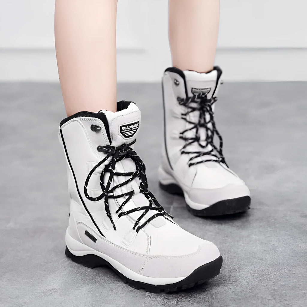 Women's black genuine leather mid-calf thermal snow boots with a round toe and rubber sole.