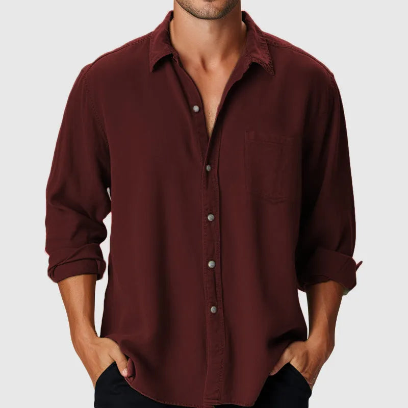 Man wearing a loose-fit long-sleeve polyester shirt with a stand collar, ideal for beach holidays.