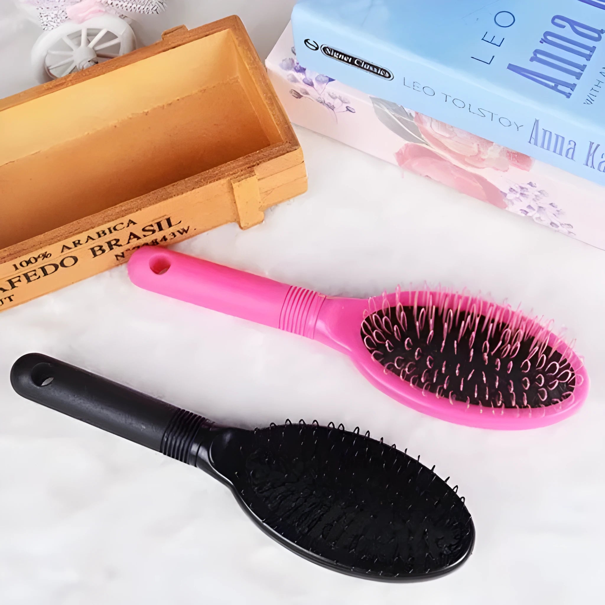 Black ring tooth hair extension comb with airbag cushion handle on white background