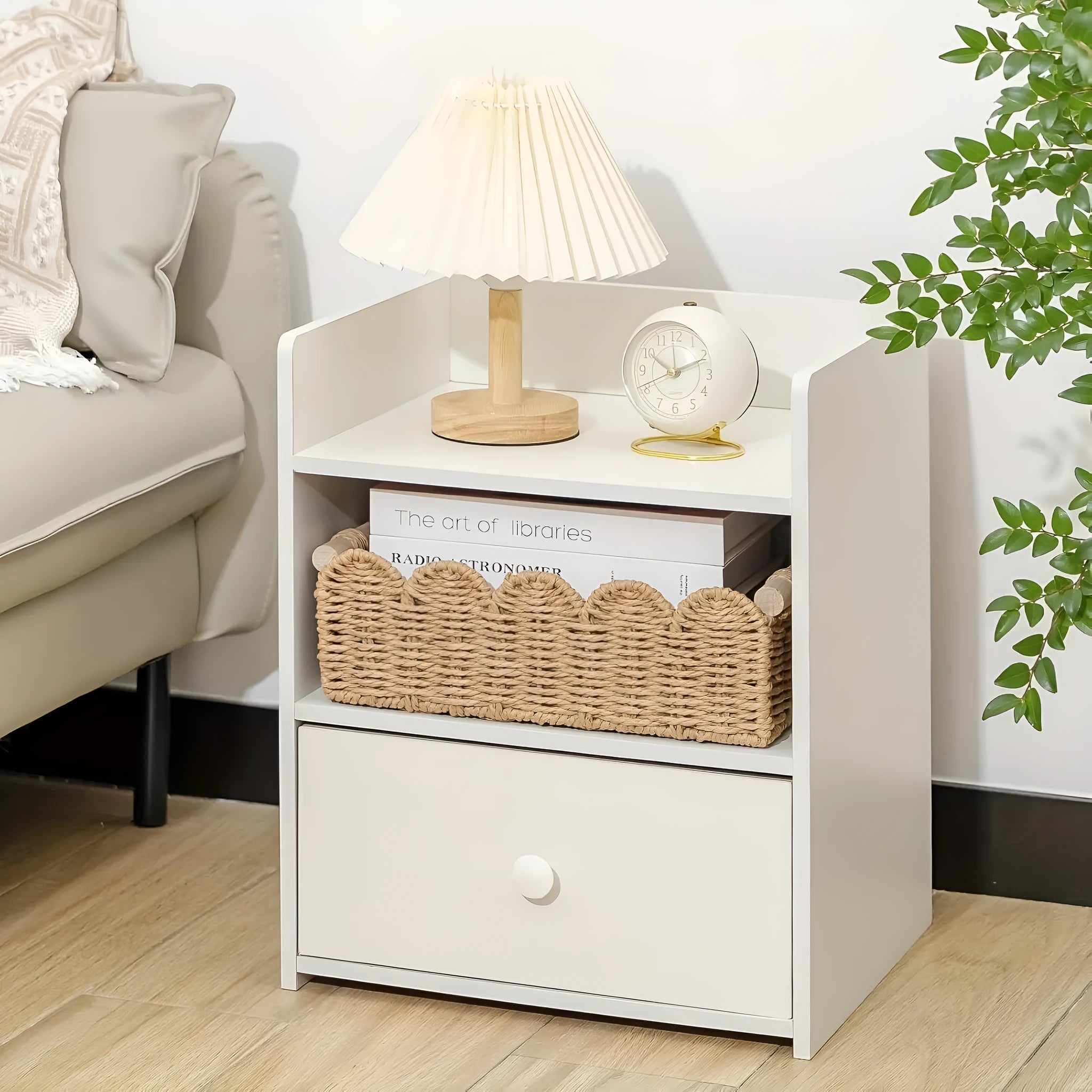 Modern woven rectangular storage basket in khaki colour on a wooden table holding remote controls and pens.