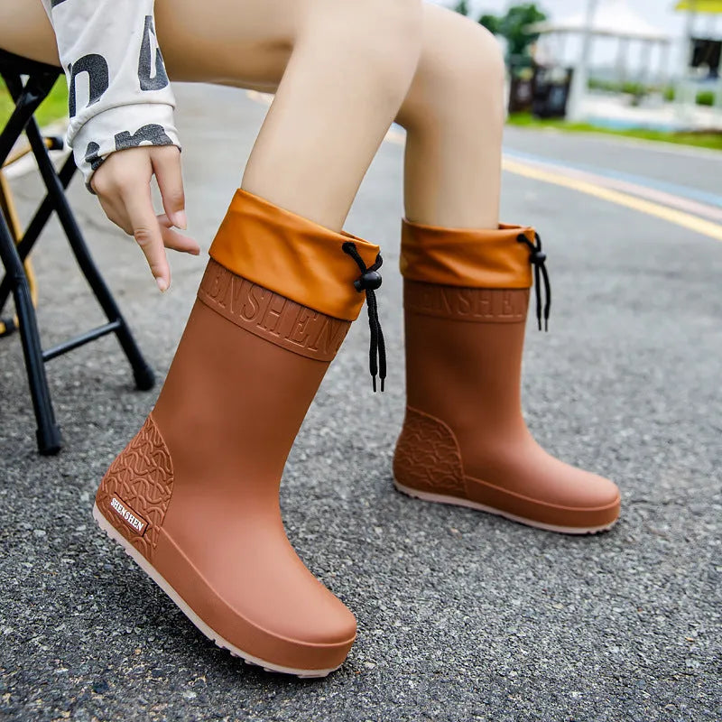 Women's solid colour PVC rain boots with non-slip soles in apricot, black, brown, and pink waterproof mouth designs