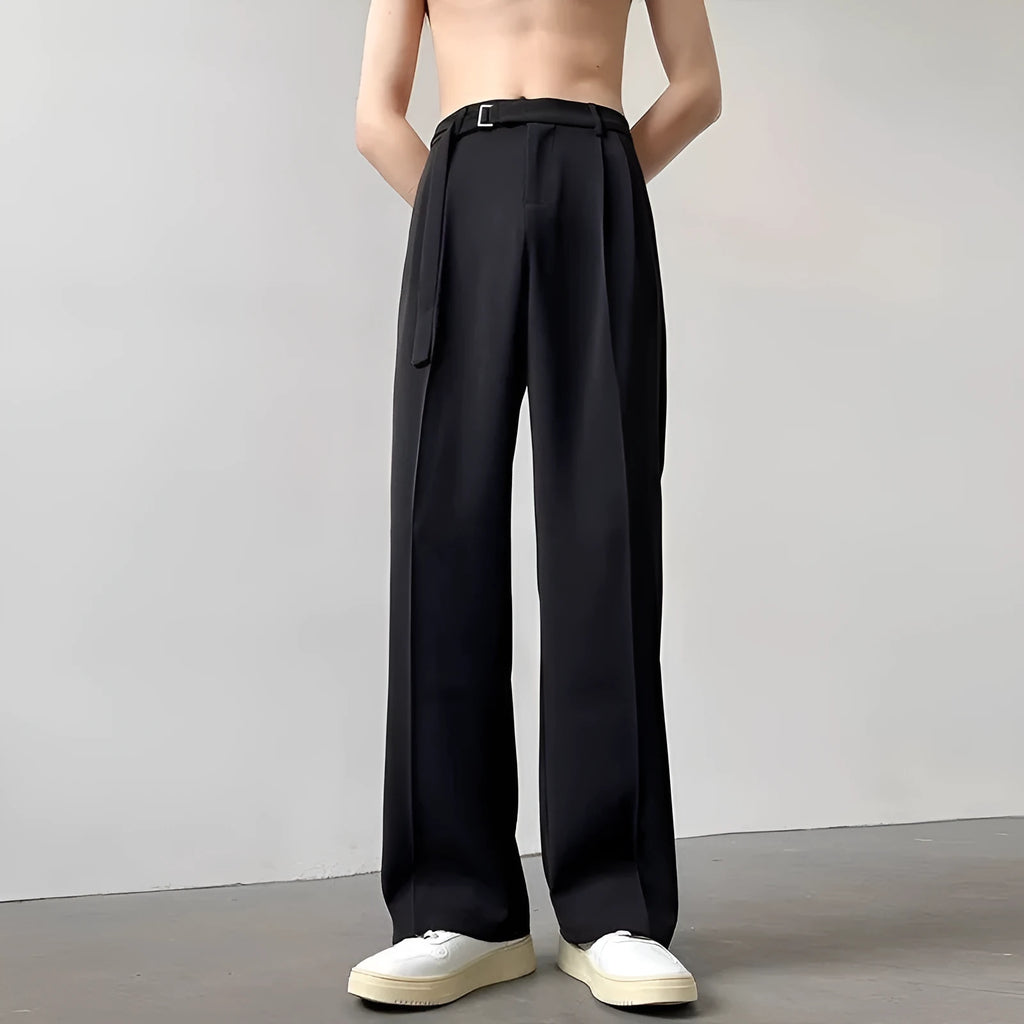 A pair of thin, black, loose-fit wide leg trousers with a straight leg opening, laid flat.