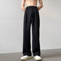 A pair of thin, black, loose-fit wide leg trousers with a straight leg opening, laid flat.