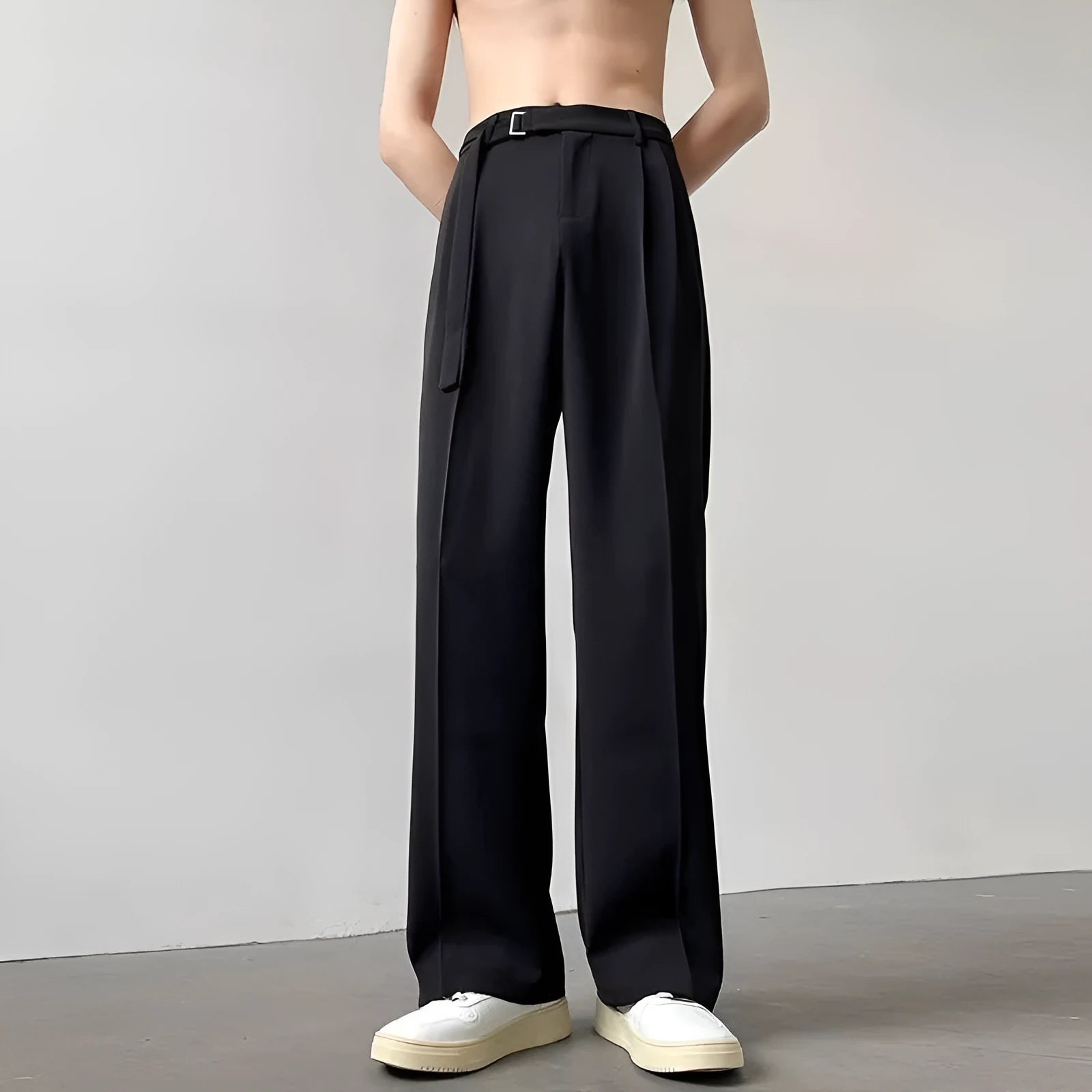 A pair of thin, black, loose-fit wide leg trousers with a straight leg opening, laid flat.