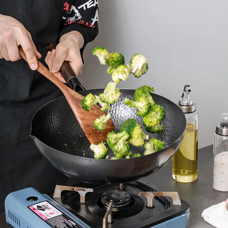 Traditional black iron wok with wooden handle measuring 32cm