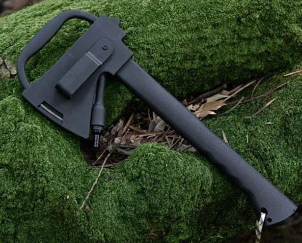 Black survival tactical axe with stainless steel blade and K sheath on outdoor rocky surface