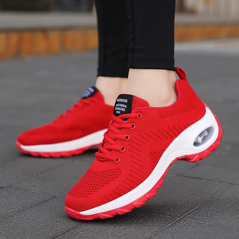 Women's black mesh lace-up sneakers with round toe and mid heel on white background