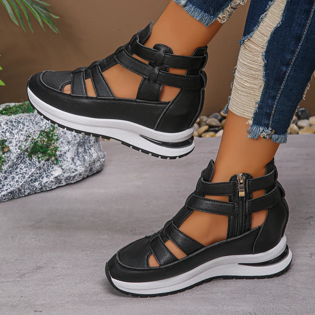 Women's black close-toed sandals with hollow-out patterning and platform sole, showing Velcro fastening