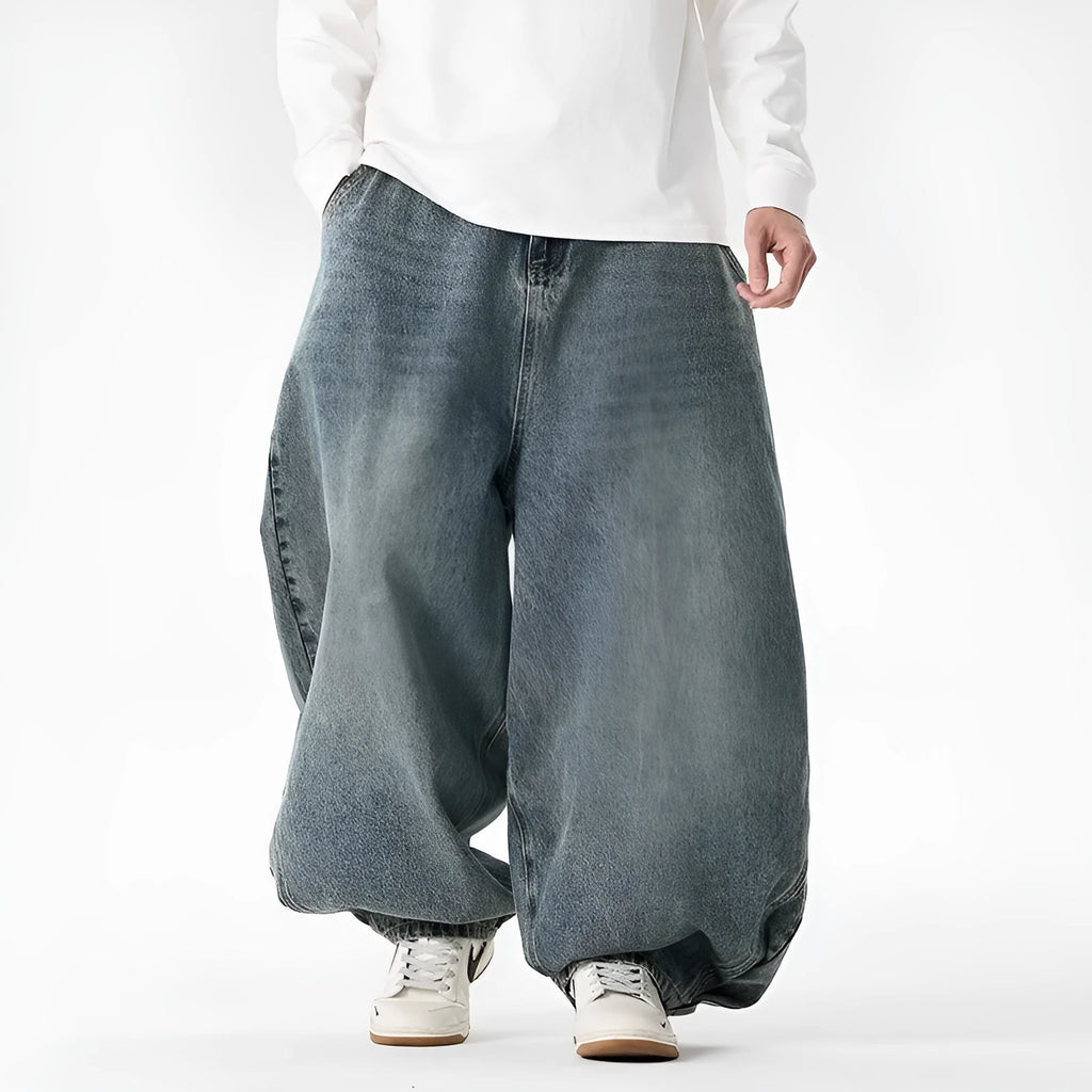 Men's plus size baggy jeans in light blue denim with wide straight legs and a low waist.