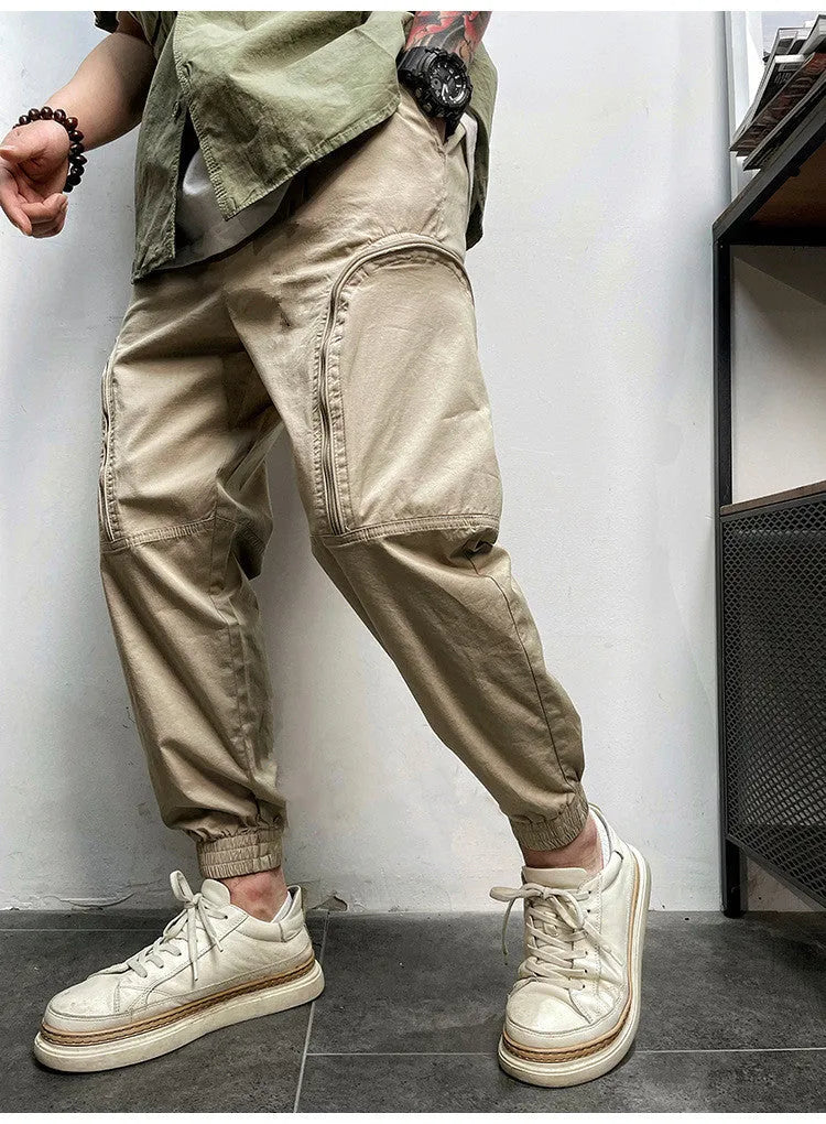 Men's loose-fit cotton cargo trousers with elastic waist, zipper, and multiple big pockets in army green