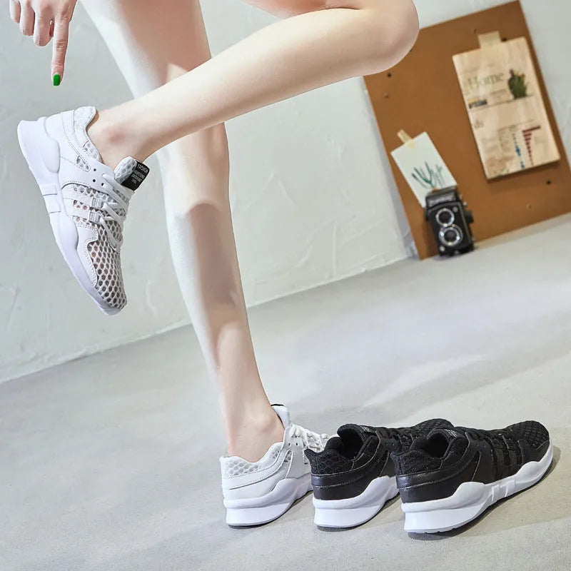 Breathable hollow-out mesh sneakers in black on a white background.