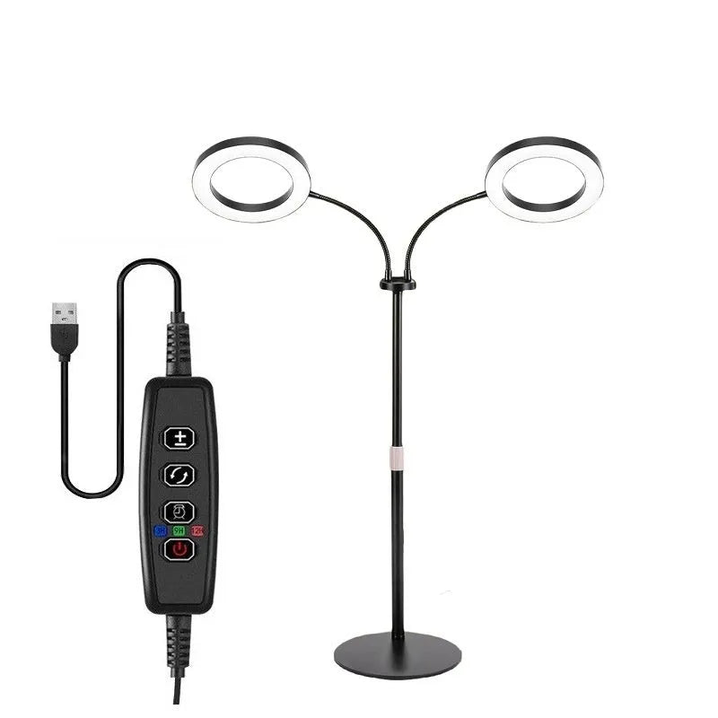 A white 6-inch angel ring LED grow light on a tall, thin adjustable floor stand, positioned next to indoor houseplants.