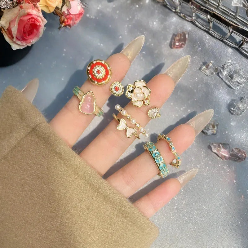 Adjustable vintage-style copper ring with gourd, flower, and bow design featuring inlaid zircon stones.