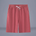 A pair of solid colour cotton linen cropped pants with a drawstring waist, shown in Army Green.