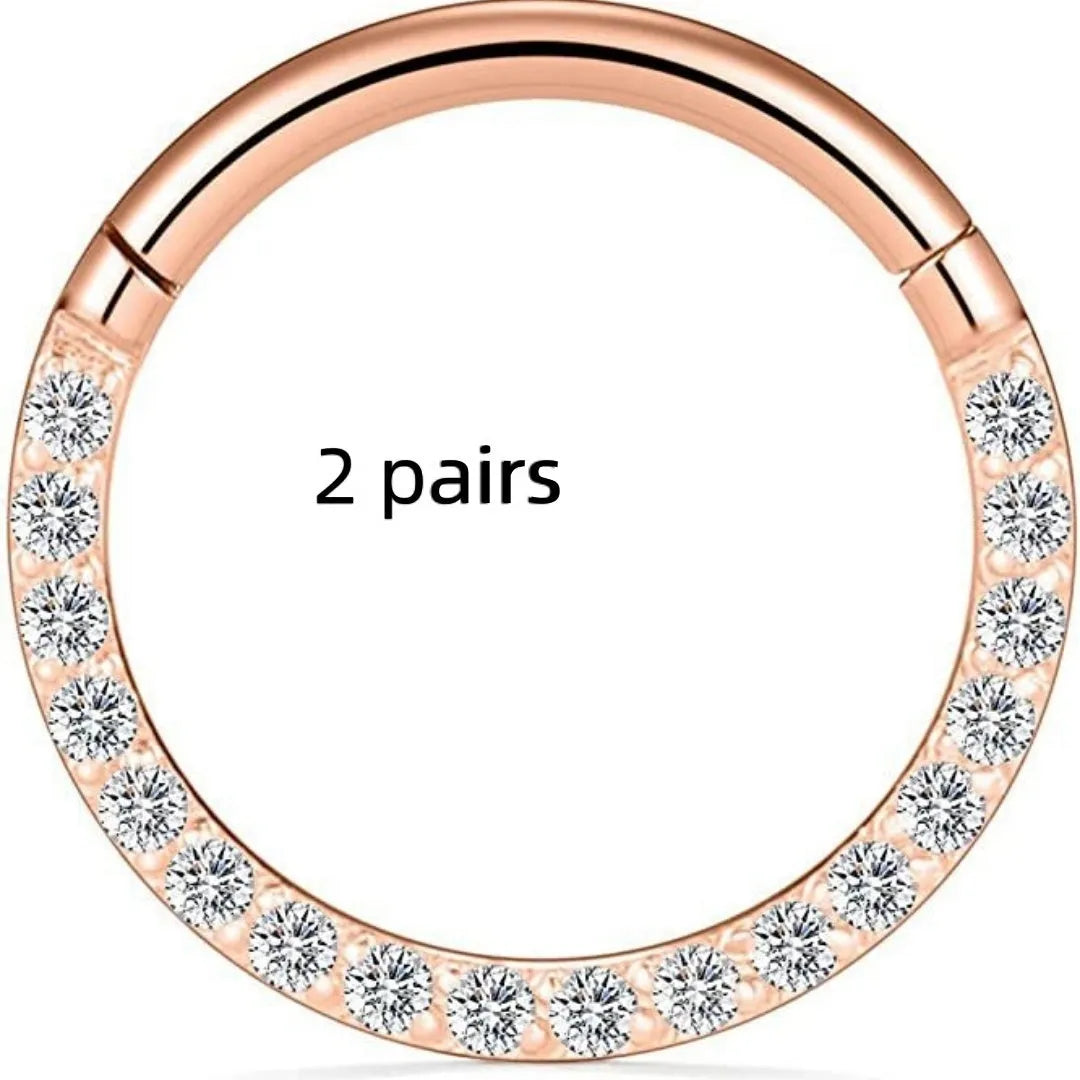 Two pairs of round, seamless 316 stainless steel nose rings showing black, gold, rose gold, and steel colour finishes.