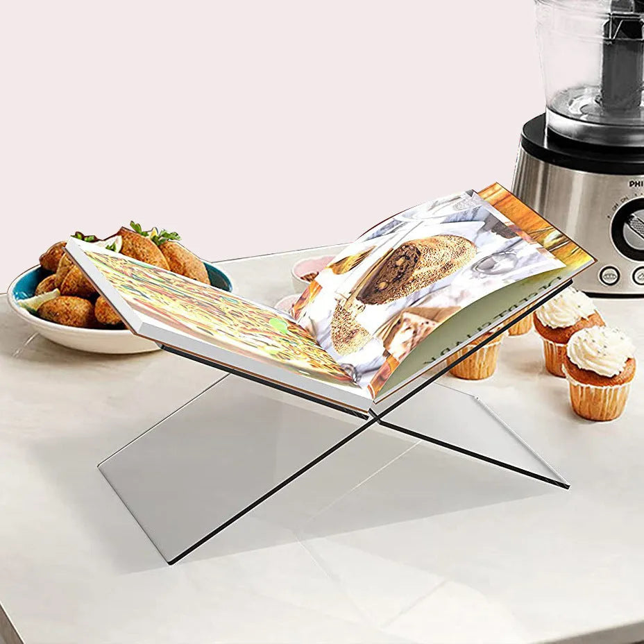Clear acrylic X-shaped book reading rack displaying books on desktop