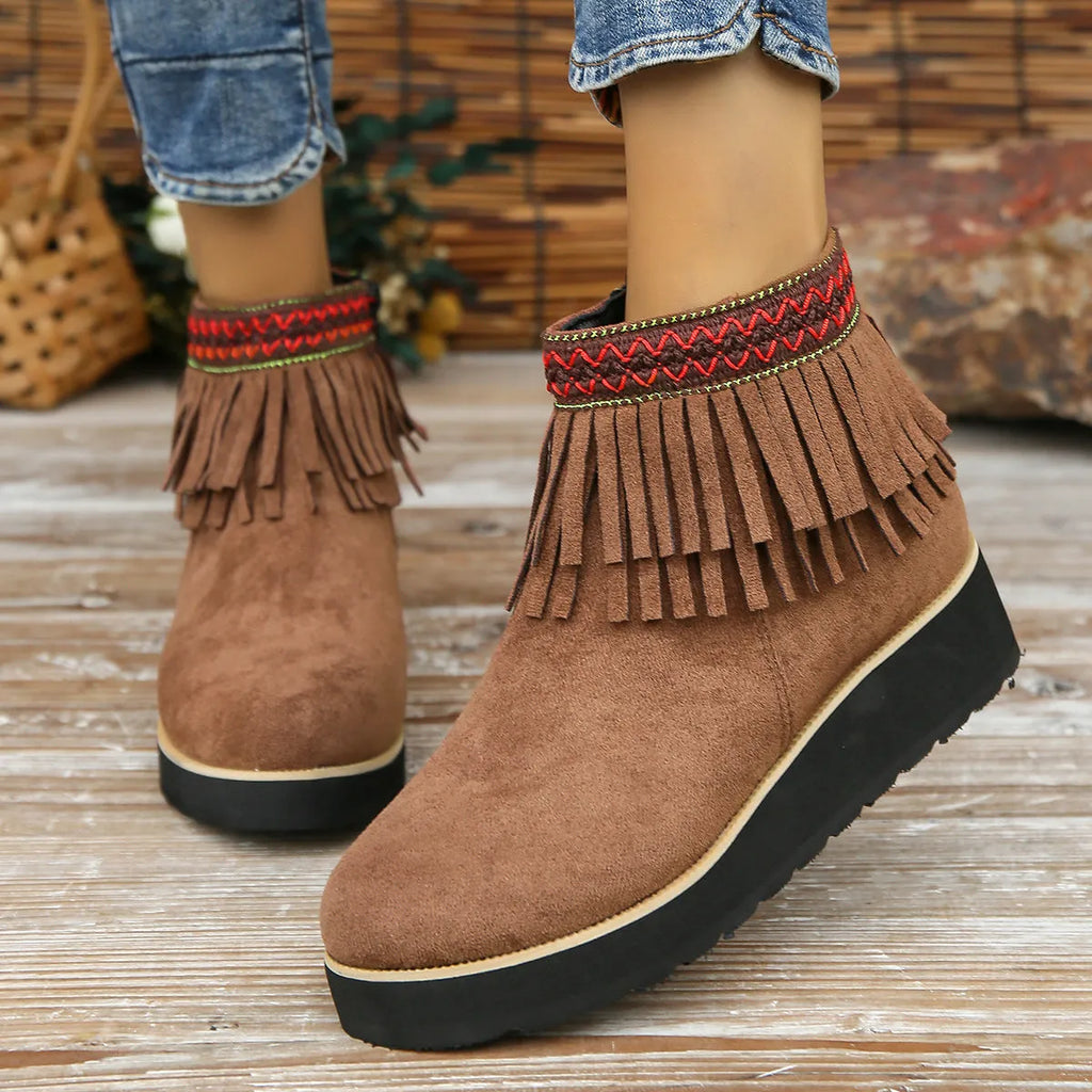 Women's dark brown suede wedge ankle boots with side zipper and tassel detail on a thick rubber sole.