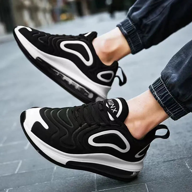 Men's black lace-up sneakers with thick sole and round toe on a white background