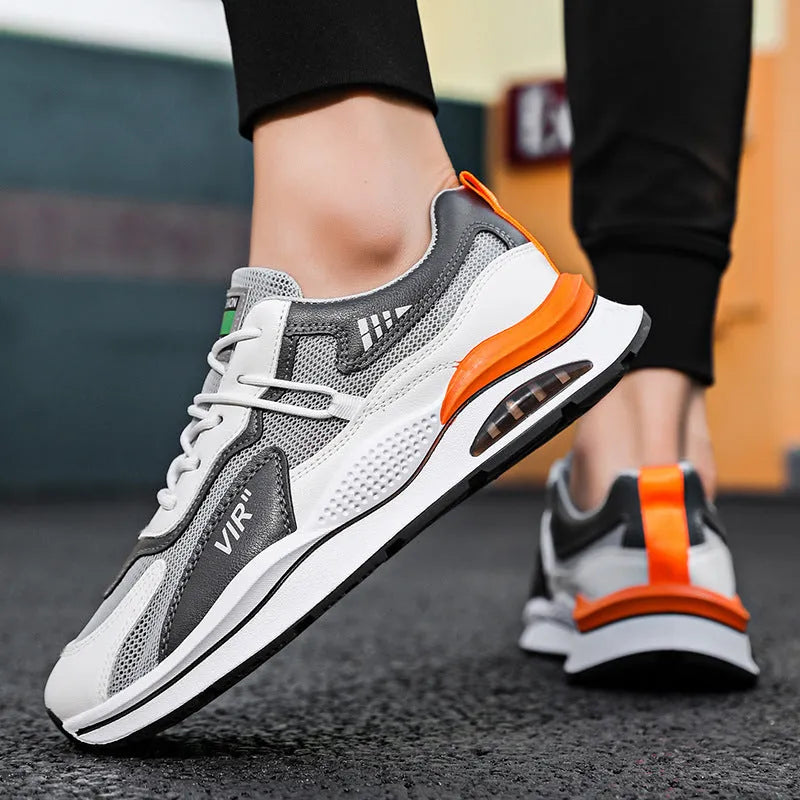 Men's grey and black mesh running shoes with round toe and mid-top design on white background