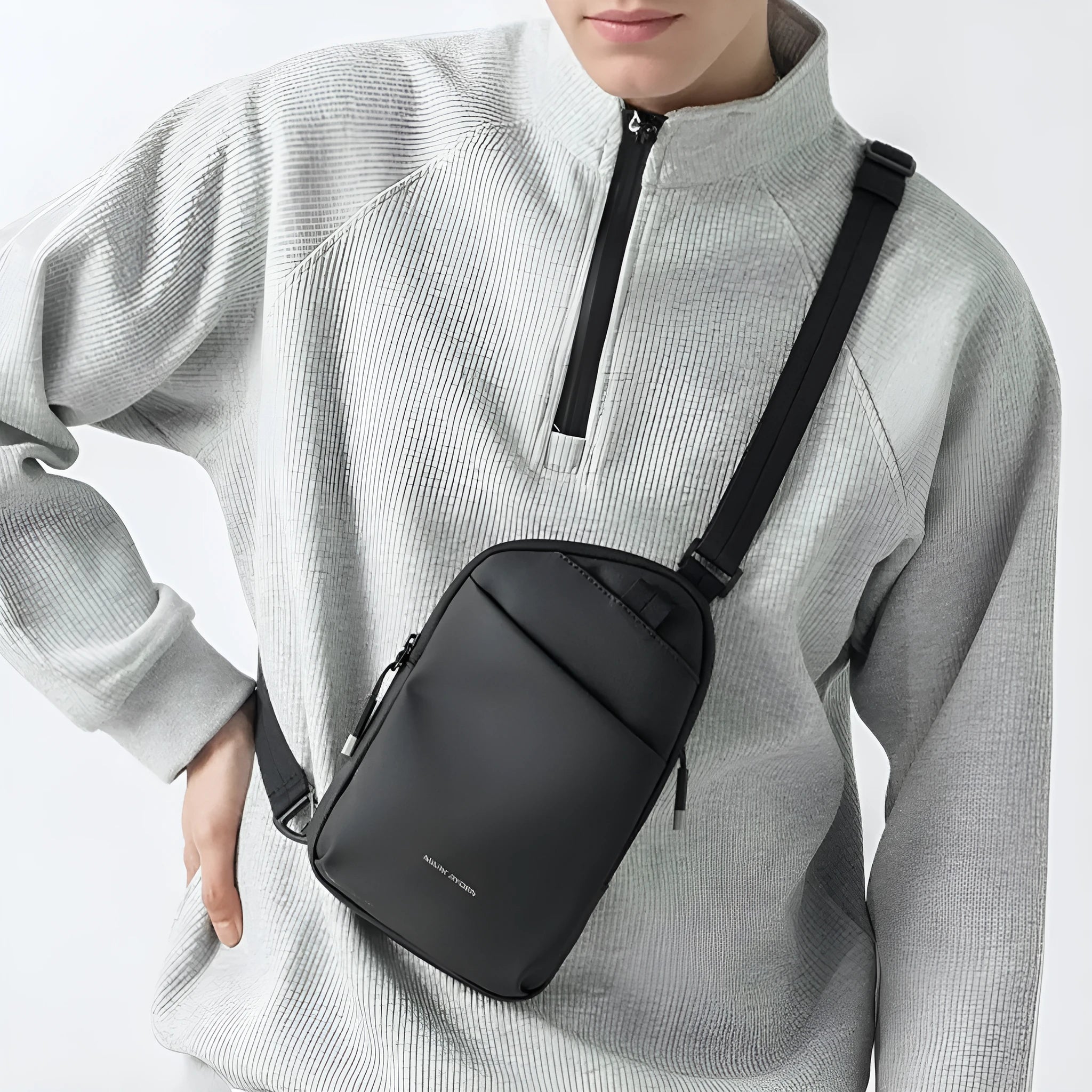 Men's black Oxford cloth crossbody bag showing reinforced sewing thread detail