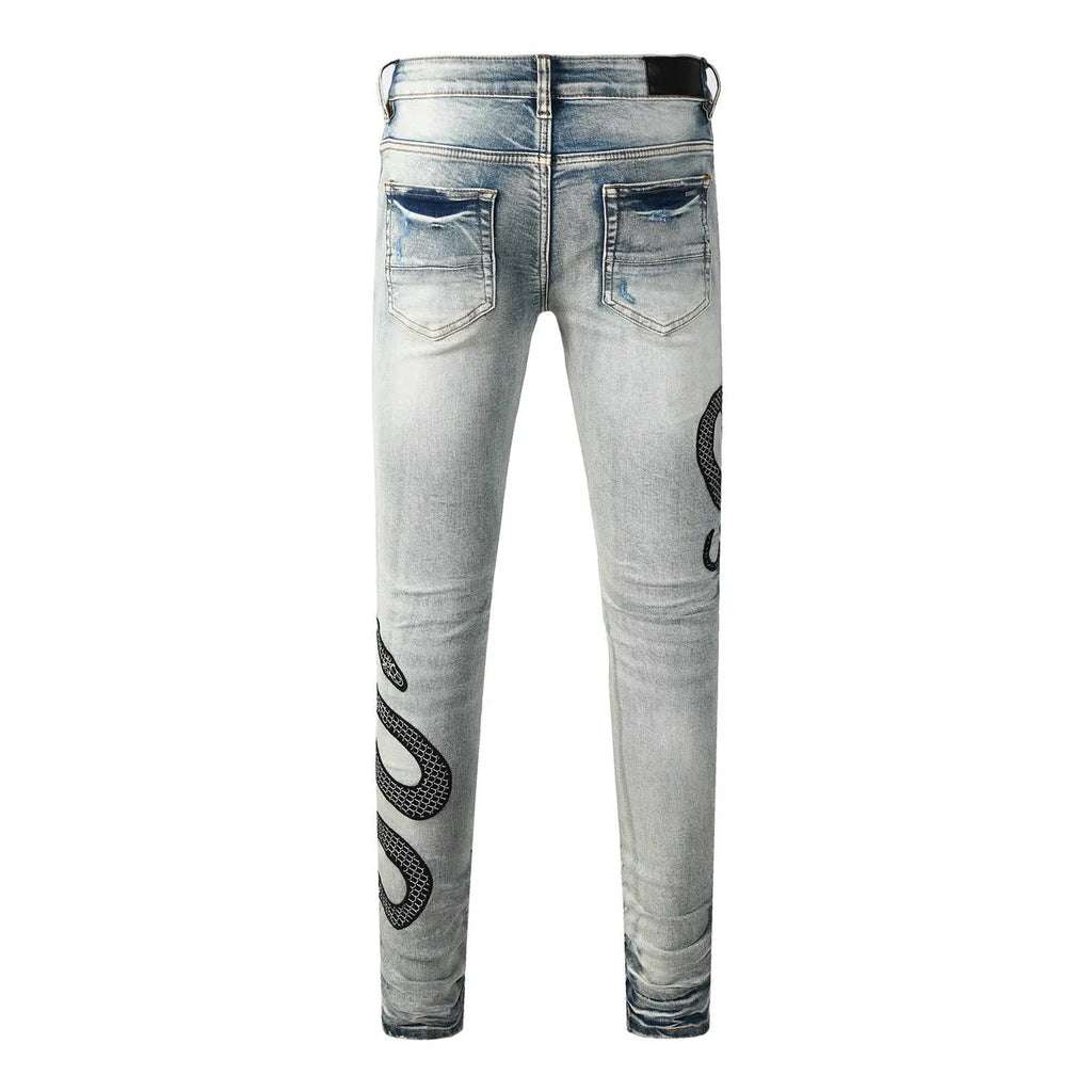 Men's distressed blue skinny jeans with a retro wash, shown with a button fly and a tight leg fit.