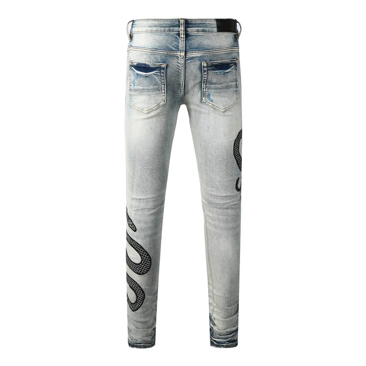 Men's distressed blue skinny jeans with a retro wash, shown with a button fly and a tight leg fit.