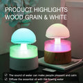 White rain cloud-shaped humidifier and essential oil diffuser on a surface