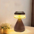 Small modern bedside LED lamp in orange with USB charging cable, showing dimmable light feature.