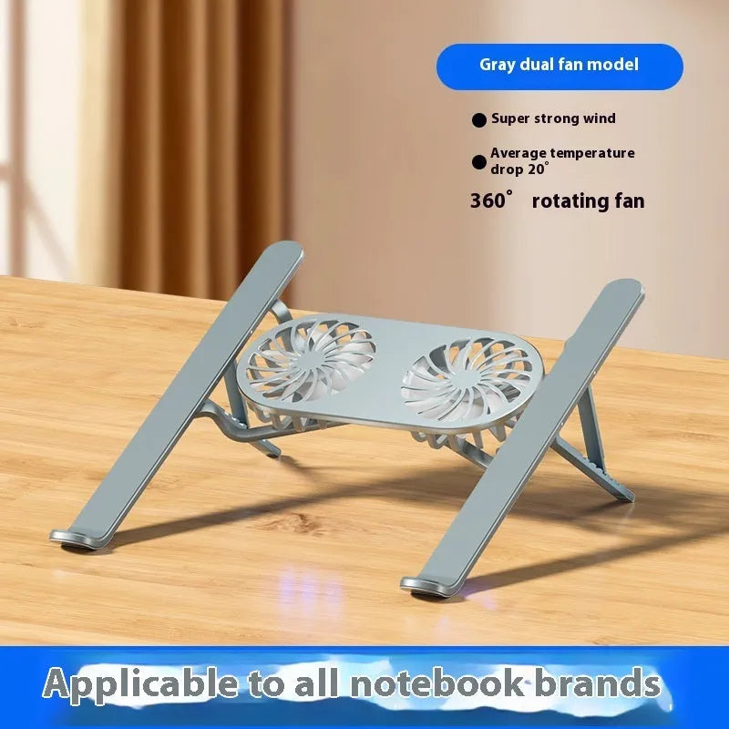 Silver aluminium alloy laptop cooling stand with dual fans in a raised, open position on a desk.