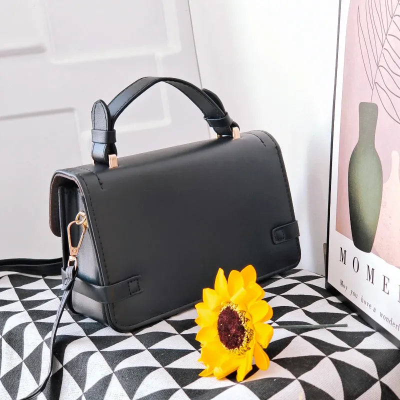 Small square retro pattern crossbody bag in PU leather with floral stitching.