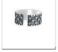 Adjustable sterling silver ring featuring a raised five-pointed star geometric pattern on the band.