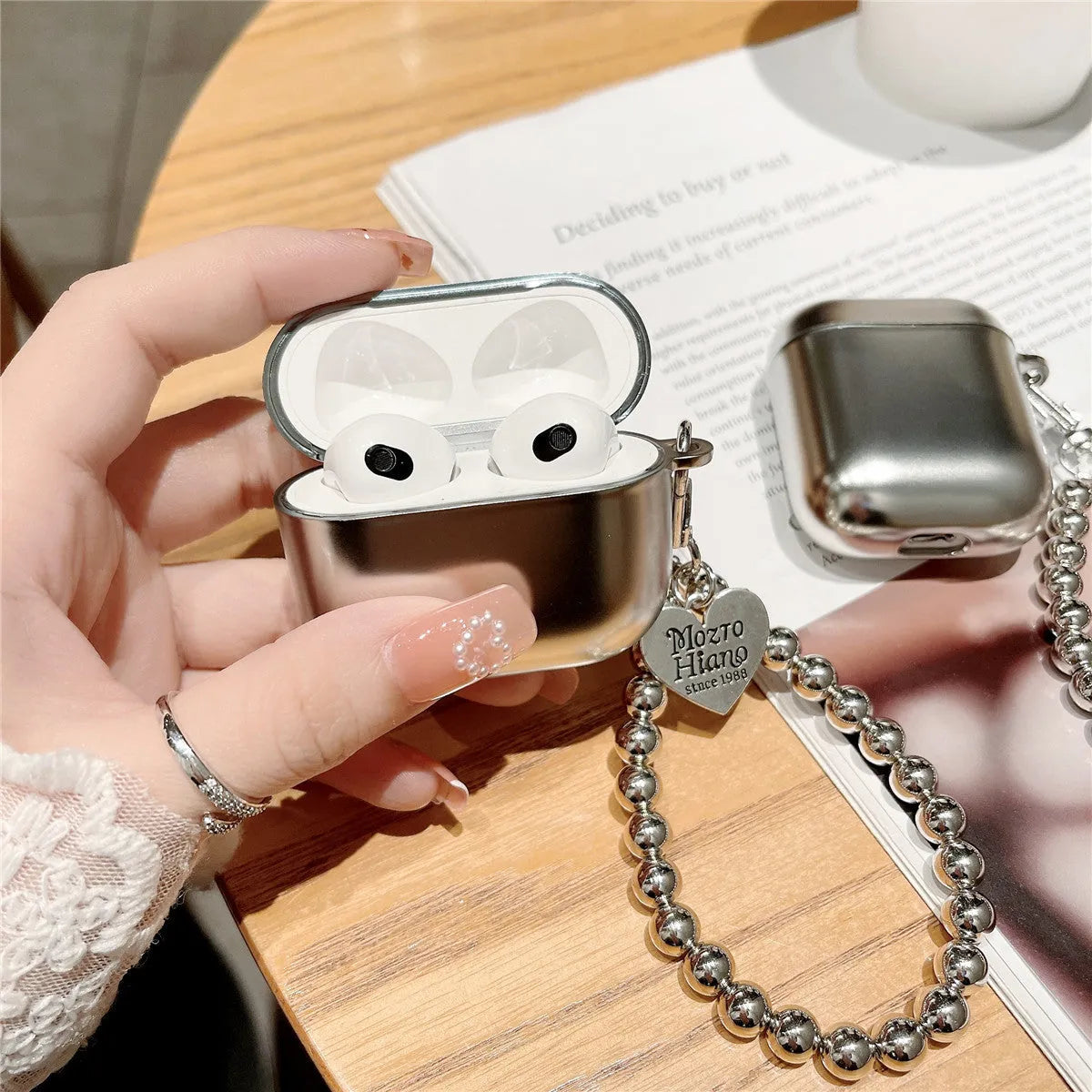 Matte plating protective case for AirPods with integrated bracelet showing electroplated finish
