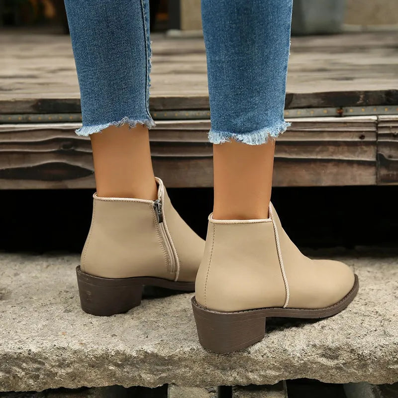 Women's chunky mid heel suede ankle boots with side zipper in off-white, front view