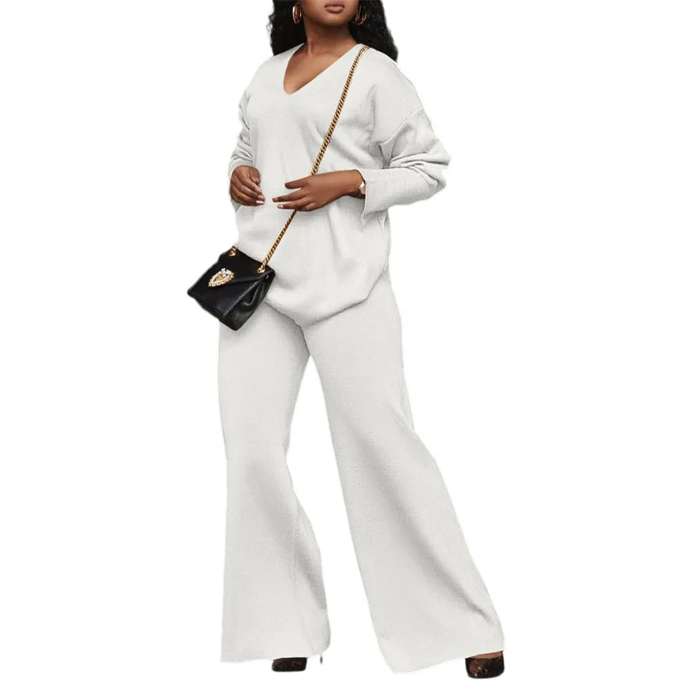 Women's brown suede two-piece casual suit with long sleeves and trousers on a hanger