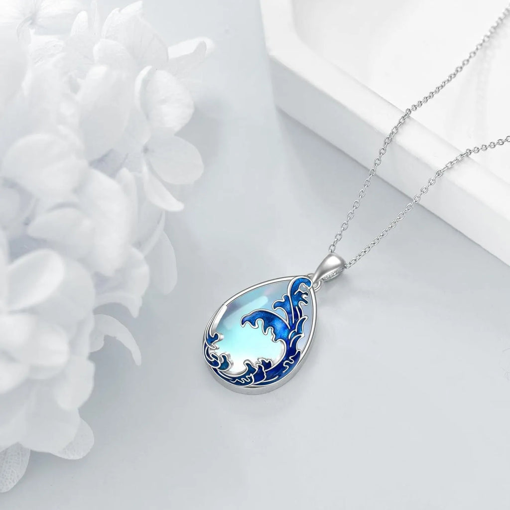 Blue heart pendant necklace on silver-tone chain with moonstone blue finish