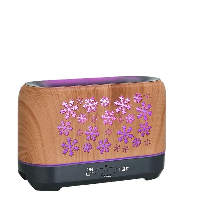 Colourful snowflake wood grain aromatherapy humidifier with glowing flame effect on a desktop.