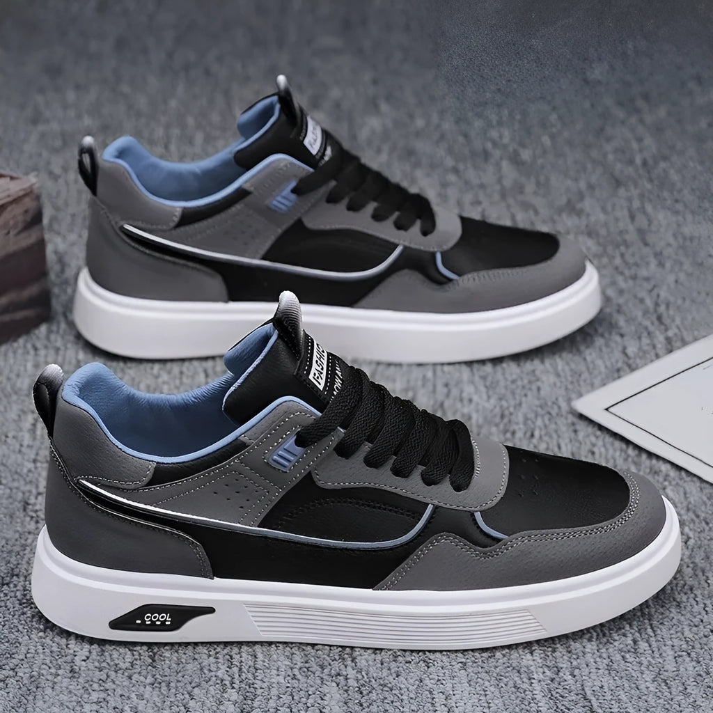 Men's low-top canvas board shoes in solid colour with leather stitching detail on a neutral background.