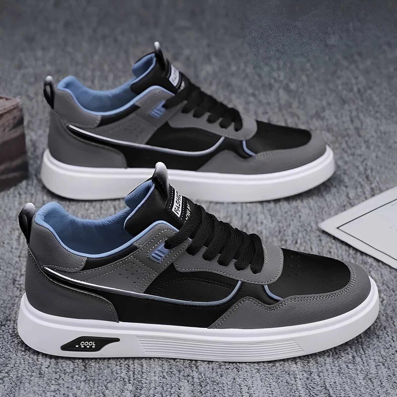 Men's low-top canvas board shoes in solid colour with leather stitching detail on a neutral background.