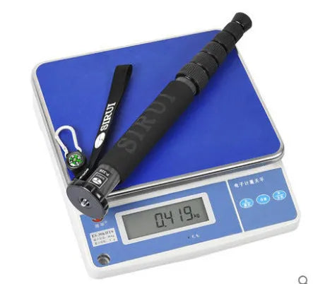 Black carbon fibre monopod for DSLR cameras extended to maximum height
