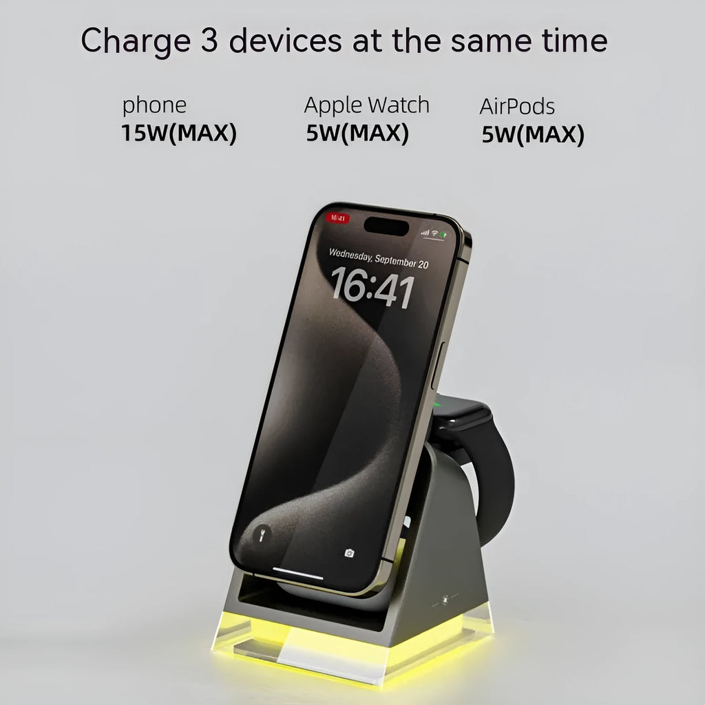 Black three-in-one magnetic wireless charger with night lamp charging phone, watch, and headset on a desk