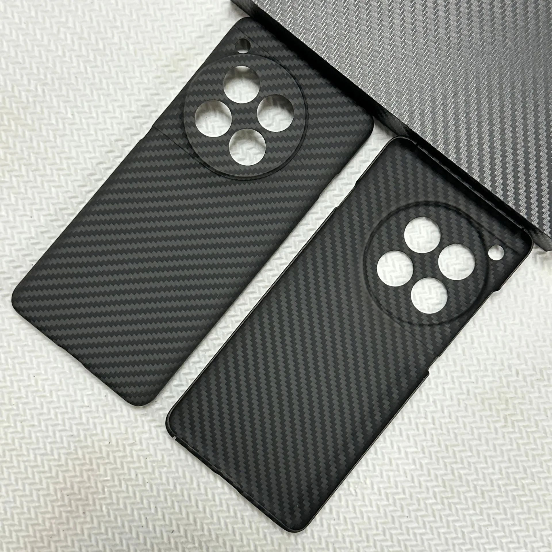Black hand-woven Kevlar anti-wear phone case for OnePlus 12 with crater texture