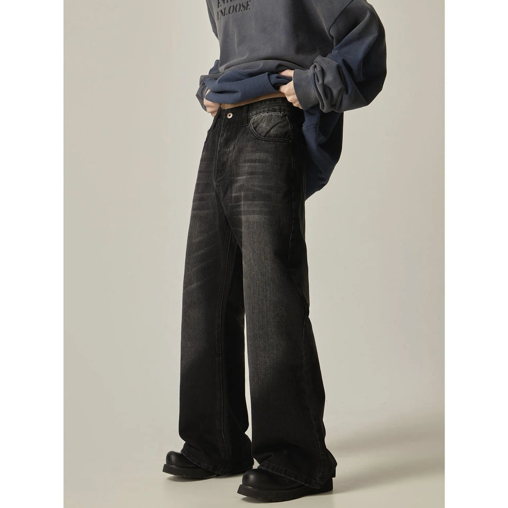 Black loose straight leg retro jeans on a hanger showing zipper fly detail