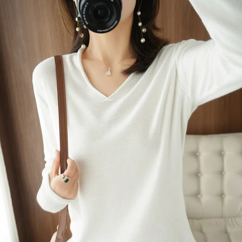 Women's V-neck long sleeve knit top in turmeric colour on a hanger