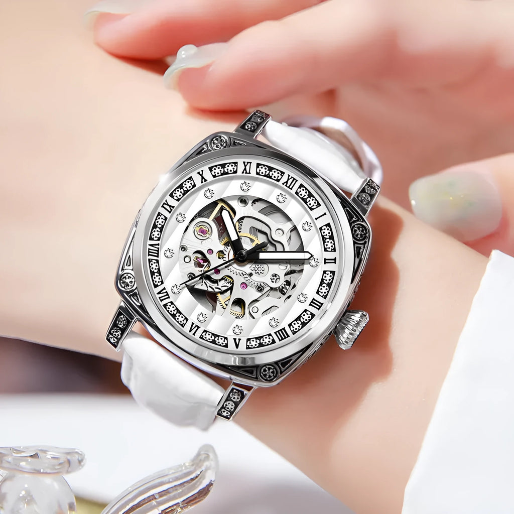 Mechanical watch with luminous hands on a leather strap, shown in black, red, steel, and white colour options.