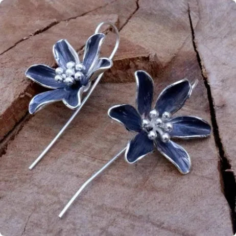 Pair of purple retro-style flower-shaped alloy earrings for women.